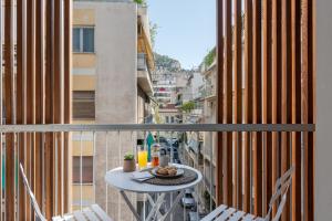 a balcony with a table and chairs on a city street at Trikoupi 95 by ABR in Athens