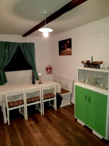 a room with a white table and a green cabinet at Bakina iža in Duga Resa