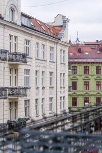 a large white building with red roof at Kwiatowa Apartments Poznań City Center by Renters in Poznań