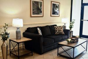a living room with a black couch and two tables at La Quinta by Wyndham Nashville Airport/Opryland in Nashville +46 photos