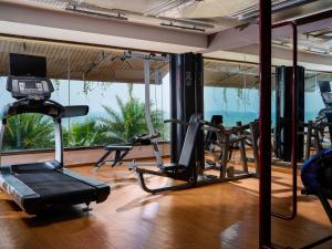 a gym with cardio equipment and a view of the ocean at The Bheemli Resort Managed by AccorHotels in Visakhapatnam
