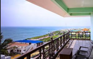 a balcony with a view of the ocean at Rosan Heritage - A Beach Villa in Kanyakumari