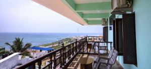 a balcony with chairs and a view of the ocean at Rosan Heritage - A Beach Villa in Kanyakumari