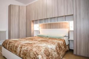 a bedroom with a large bed with wooden walls at Fontanesi Suite in Bologna