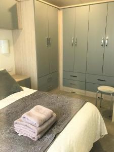 a bedroom with a bed with two towels on it at Cumbria Reach in Longtown