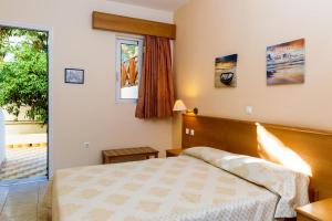 a bedroom with a bed and a window at Summer Memories Aparthotel in Pefki Rhodes