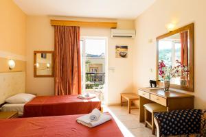 A bed or beds in a room at Summer Memories Aparthotel