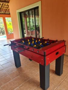 a red and black foosball table in a room at Chácara Santo Antonio in Brotas