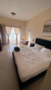 a bedroom with a bed and a table in a room at Full sea view Studio high floor in Ras al Khaimah