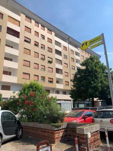 a large building with cars parked in front of it at Renovated apartment, center and hospital in Udine