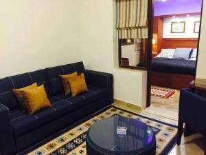 a living room with a blue couch and a mirror at The Royal Luxury Tiger Patio in Amman