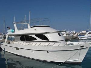 a white boat is docked in the water at The Royal Luxury Tiger Patio in Amman