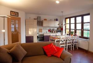 a living room with a couch and a kitchen with a table at Abendsonne in Mirow