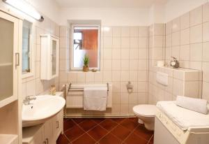 a white bathroom with a sink and a toilet at Abendsonne in Mirow