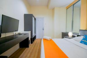 Postel nebo postele na pokoji v ubytování Sans Sunset Point Seminyak