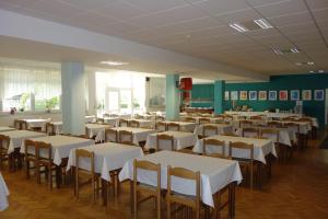 a room full of tables and chairs with white table cloth at Mladinski dom - Hostel in Klagenfurt