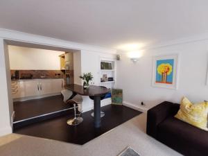 a living room with a couch and a table at Sandsifter at 4 Trencrom Court, Carbis Bay,St Ives, Cornwall in Carbis Bay