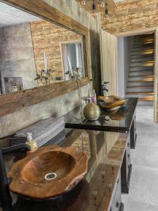 a bathroom with a wooden sink on a counter at Koča na samem Prestiž in Šalovci