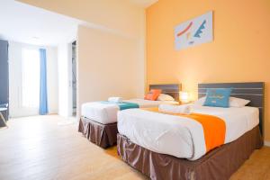 Postel nebo postele na pokoji v ubytování Sans Sunset Point Seminyak + 37 fotografií