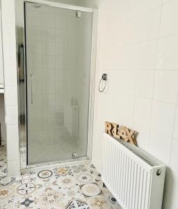 a shower with a glass door in a bathroom at Harbour View Killybegs in Killybegs