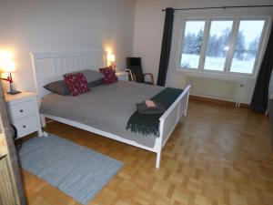 ein Schlafzimmer mit einem Bett und einem großen Fenster in der Unterkunft The Friendly Moose in Övertorneå