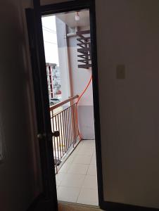 a door leading to a room with a balcony at Drea Staycation 2 Bedroom at Urban Deca Homes Marilao in Marilao