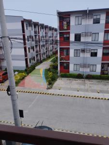 a view of an empty street with apartment buildings at Drea Staycation 2 Bedroom at Urban Deca Homes Marilao in Marilao