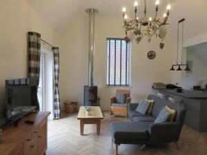 a living room with a couch and a table at Old Schoolhouse in Lairg