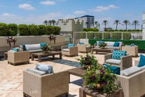 a patio with chairs and tables on a roof at The Commerce Casino & Hotel in Commerce