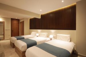 Voodi või voodid majutusasutuse Pyramid Front Hotel toas
