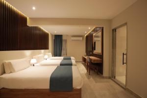 Voodi või voodid majutusasutuse Pyramid Front Hotel toas