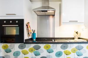 A kitchen or kitchenette at Stylish loft apartment moments from beach by Whitstable-Holidays, Bowline