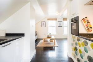 A kitchen or kitchenette at Stylish loft apartment moments from beach by Whitstable-Holidays, Bowline