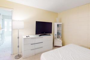 a bedroom with a flat screen tv on a dresser at Gulf Terrace 126 in Destin