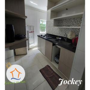 a kitchen with a refrigerator and a counter top at Ap Privativo Jockey, uma quadra da praia, Sentir-se em casa! in Vila Velha