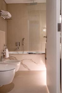 y baño con 2 lavabos y bañera. en Alnoon at Address Beach Resort Fujairah, en Sharm