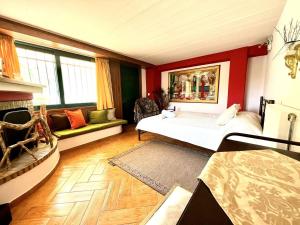 a room with a bed and a couch in it at Estate Tsiati - Κτήμα Τσιάτη in Nafplio