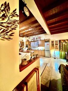 a large kitchen with a clock on the wall at Estate Tsiati - Κτήμα Τσιάτη in Nafplio
