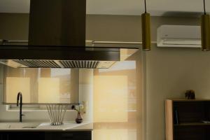 a kitchen with a sink and a stove at Spacious & Minimal Apartment Near Airport Peania Coniann Filoxenia in Paianía +22 photos