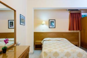 A bed or beds in a room at Summer Memories Aparthotel