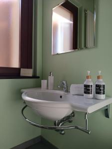lavabo blanco en el baño con espejo en CASAL MICELIO, en Udine