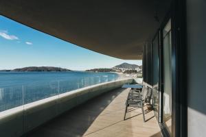 a balcony with a view of the water at Beachfront luxury apartment in Budva