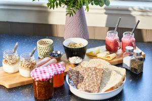 a table with bread and other food items on it at Hovra Vandrarhem in Korskrogen