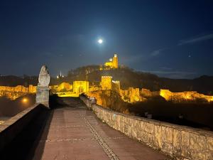 a view of a castle at night with the moon at HOTEL BOLYARI in Veliko Tŭrnovo
