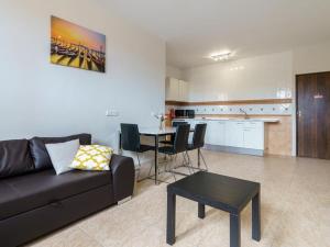 a living room with a couch and a table and a kitchen at Apartment La Cala Boulevard in La Cala de Mijas