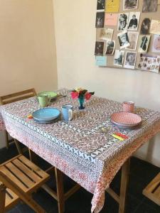 a table with plates and utensils on it at The Studio, Trelugga in Helston