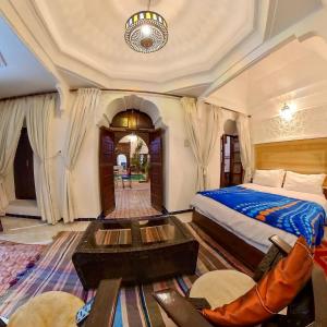 1 dormitorio con 1 cama y 1 mesa en Riad Dar Moulay Ali, en Marrakech