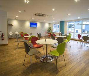 a dining room with tables, chairs, and tables in it at Citilodge Wakefield Hotel by Roomsbooked in Wakefield