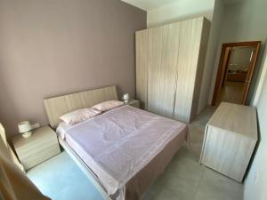 a small bedroom with a bed and a mirror at Sliema Central 2-Bedroom on a Quiet Street, Near Valletta by Malta Weekend in Sliema