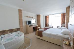 Postel nebo postele na pokoji v ubytování Hotel Caprea